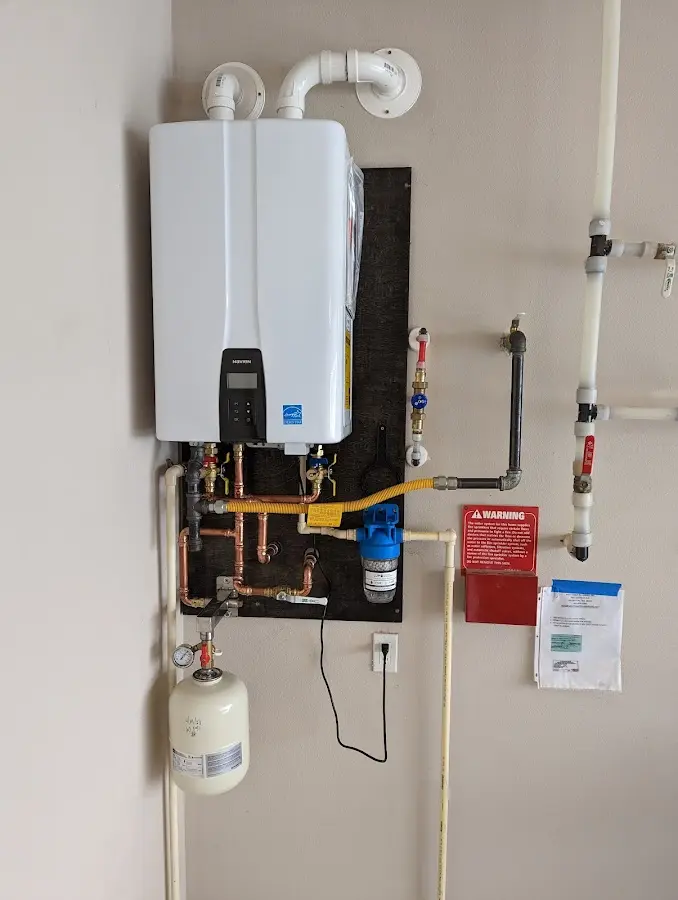 Professional plumber installing copper piping in a Grantsville home